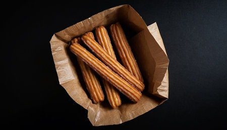 Churros in a paper box on a black background, top viewの素材