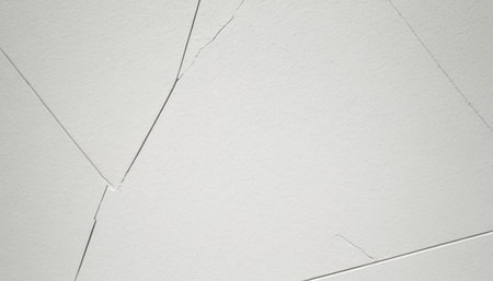 Cracked white wall background or texture. Cracks in the wall.の素材