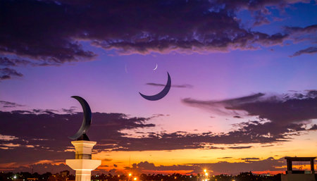 Ramadan Kareem background with crescent moon and mosque at sunsetの素材