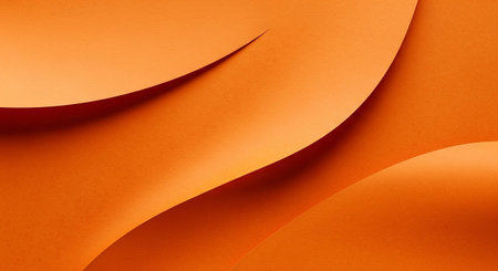 This abstract smooth, flowing curves of orange paper that create a sense of gentle waves and organic forms. Soft shadows are cast between the layers of paper, adding depth and dimension to the composition. The lighting is soft and diffused, highlighting the subtle texture of the paper and the vibrant orange hue. serves as a versatile background orの素材