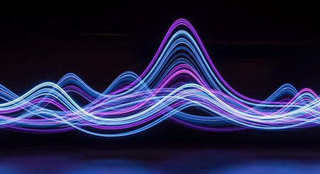 A abstract composition showcasing dynamic wave patterns formed by luminous light trails. The dominant colors are vibrant neon purple and electric blue, with touches of pink and magenta, set against a deep, dark background. The light lines twist and curve, creating a sense of fluid motion and energy. This visual could represent sound frequencies, digital data flow, or a futuristic aesthetic. The contrast between the bright lights and the dark void is striking.の素材