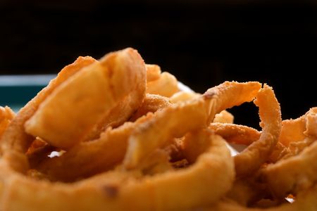Close up shot of Onion Rings with Black Backgroundの写真素材