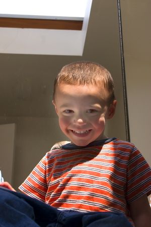 Happy Little Boy Looking Down and Smiling