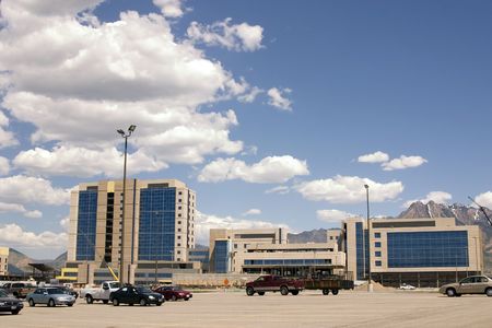 Mirrored Construction Buildings and the Parking Lot with the Clouds in the Skiesの写真素材