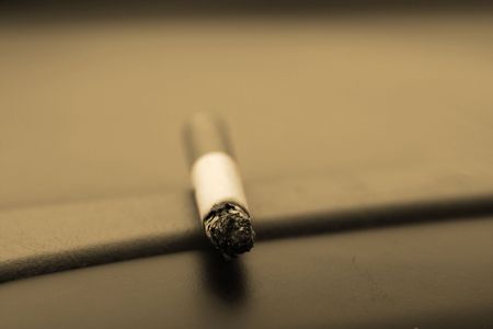 Single Cigarette Laying on the Deck - Retro Lookの写真素材