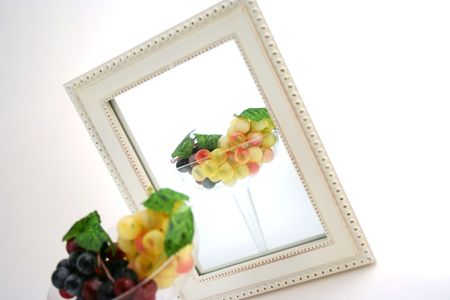Isolated Grapes In a Glass in front of a Mirrorの写真素材