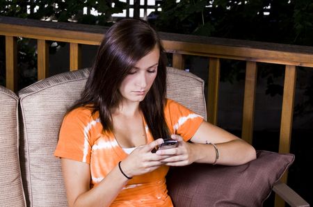 Close up on a Beautiful Girl Texting Outsideの写真素材