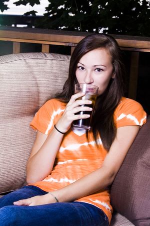 Close up on a Beautiful Girl Talking Drinking Soda Outsideの写真素材