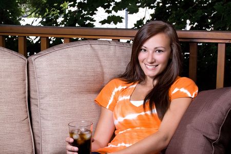 Close up on a Beautiful Girl Talking Drinking Soda Outsideの写真素材