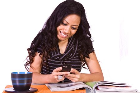 Beautiful Woman Relaxing by Reading a Magazine and Drinking Coffeeの写真素材