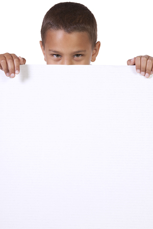Cute little Boy peeking behind a blank signの写真素材