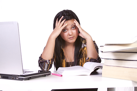 Isolated Shot of a Cute Woman Studying at her Deskの写真素材