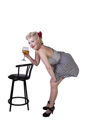 Beautiful pinup retro girl with wine enjoying cool air from fan - Isolated White Backgroundの写真素材