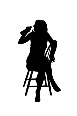 Silhouette of a woman on a chair drinking beerの写真素材