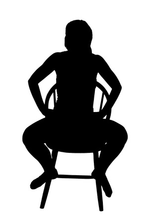 Silhouette of a woman on a chair の写真素材