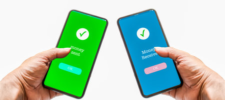 A person's hand holds a smartphone on screen with message money sent and received. Concept of financial transactions with mobile devices. Closeup, payment, money, transfer, shopping. White backgroundの写真素材
