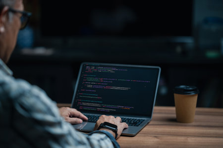 programmer coding, compiler, encode, debug, and developer application software for business corporate with laptop computer. Man programming coding web app from work at home, code show screen monitorの写真素材