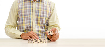 Hand holding wood cube face symbol icon to give satisfaction in service. rating very impressed....