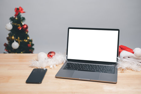 Shopping online Christmas day with laptop at home. Using computer laptop indoors to pay for goods for Christmas holiday. shopping online at home. white screen, clipping path. white background, nobodyの写真素材