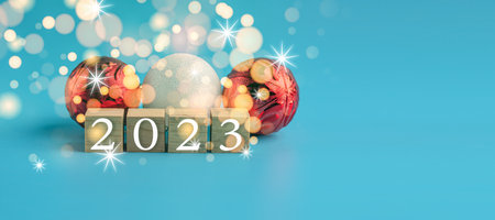 The wooden cube with the word 2022 changes to 2023. New Year Christmas Day. Concept on bokeh and blue background. Close up and copy space on top and under for design or text.の写真素材