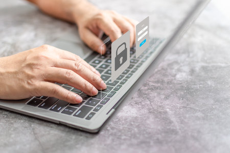 Man typing on keyboard to use computer network. Laptop screen showing login for security system....