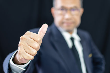 one manager man person adult positive and confident for sign agreement good job of office, businessman is professional executive standing wear suit showing thumb up and happy for business work successの写真素材