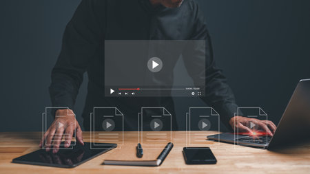Businessperson making video content of business in 2023. Man using hand and keyboard for streaming online on virtual screen, watching video on internet, live concert, show or tutorial, content onlineの写真素材