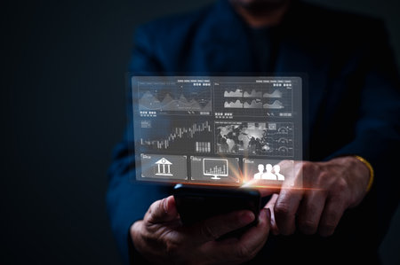 Businessman using smart phone with financial graph and chart on screen.の写真素材
