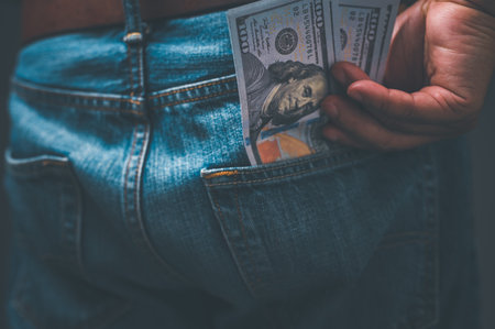 money pocket, currency, finance, business concept, a person man wearing jeans has dollars banked in...