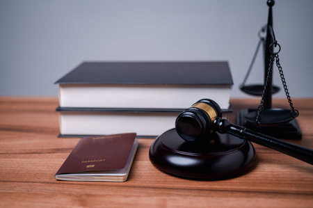 The immigration officer brought down the gavel of justice on the table, symbolizing the importance of following immigration law and the consequences of breaking it.の写真素材