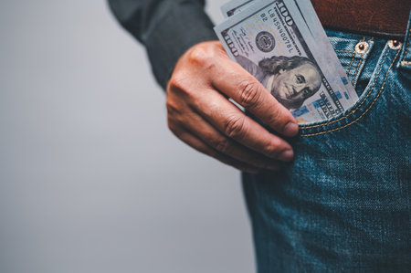 money pocket, currency, finance, business concept, a person man wearing jeans has dollars banked in his pocket.の写真素材