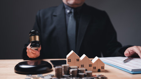 Pursuit of justice, a gavel falls in court as lawyers expose fraudulent dealings, especially in business, house investment, property transactions, and home loans, under the watchful eye of a judgeの写真素材