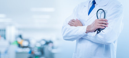 professional doctor male in clinic hold stethoscope. doctor man standing and holding stethoscope in hospital. concept for medical, medicine, health care, diagnostic, illness, listening, measurementの写真素材