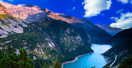 panoramic view of alpine lake in the alpsの写真素材
