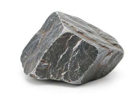 A rough, angular dark gray stone with visible striations is presented isolated on a clean white background.の素材