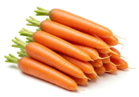 A close-up view of a pile of fresh, vibrant orange carrots with green tops, isolated on a clean white background.の素材