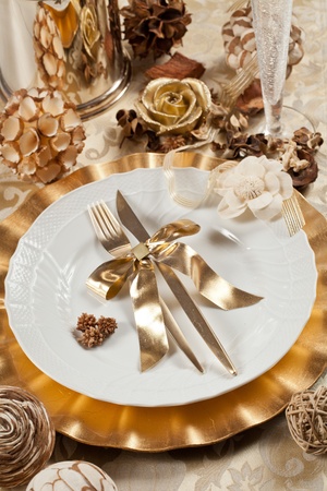 Beautiful and elegant gold place setting for christmas or celebrationsの写真素材