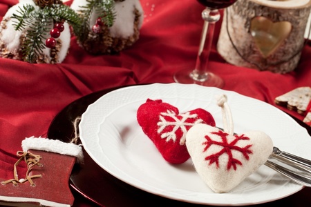 Red, romantic place setting for christmas or celebration wit white and red heartの写真素材