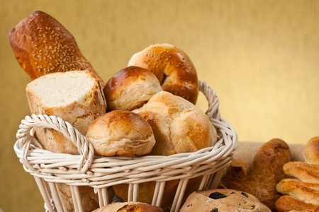 Basket of different types of gourmet brerad with flour, sesame seeds and nutsの写真素材