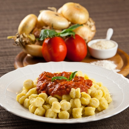 Hot cooked plate of freshly made pasta with ingredients. Tomatoes, onions, flour, parmesan cheeseの写真素材