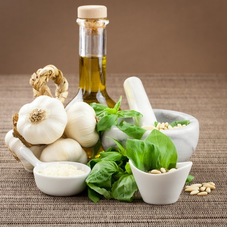 Freshly made pesto genovese dressing with ingredients. oil, parmesan cheese, garlic, pine nuts and basilの写真素材