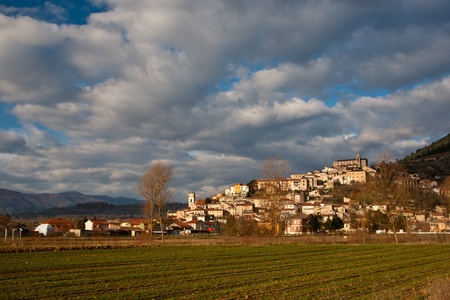 Cultivated field below Scurcola Marsicana village in Italy with a dramatic skyの写真素材