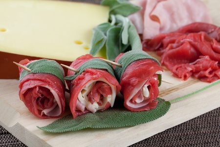 beef wraps with cheese, ham and sage ready to be cookedの写真素材