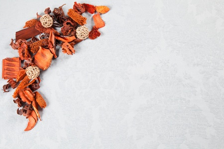 Orange autumnal decorations of dried flowers over light blue Damask pattern great for greeting cardsの写真素材