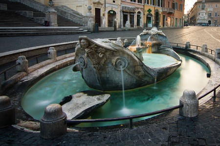 Monumental fountain in Spanish square, in the heart of Roma, at base of spanish steps at dusk with nobody aroundのeditorial素材