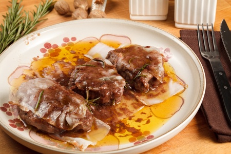 Filet mignon wrapped in bacon and cooked in red wine sauce. Served in porcelain dish with a nutmeg dusting finishの写真素材