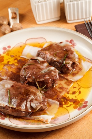 Filet mignon wrapped in lard and cooked in red wine sauce. Served in porcelain dish with a nutmeg dusting finishの写真素材