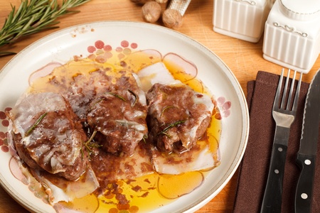 Filet mignon wrapped in lard and cooked in red wine sauce. Served in porcelain dish with a nutmeg dusting finishの写真素材