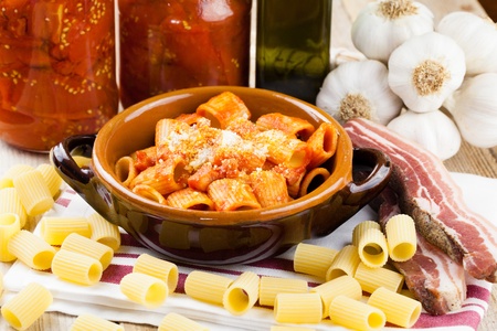 Traditional Italian recipe pasta Amatriciana  Macaroni with tomato and bacon sauce topped with parmesan cheeseの写真素材