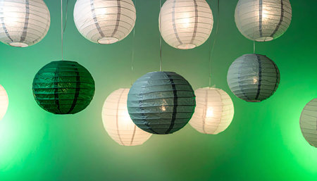 Colorful paper lanterns hanging on the ceiling in the room.の素材